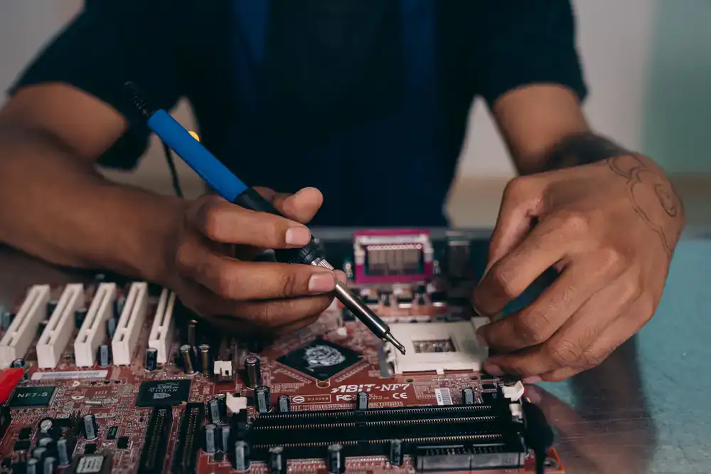 Close up of a technician's hands applying resin to a small chip